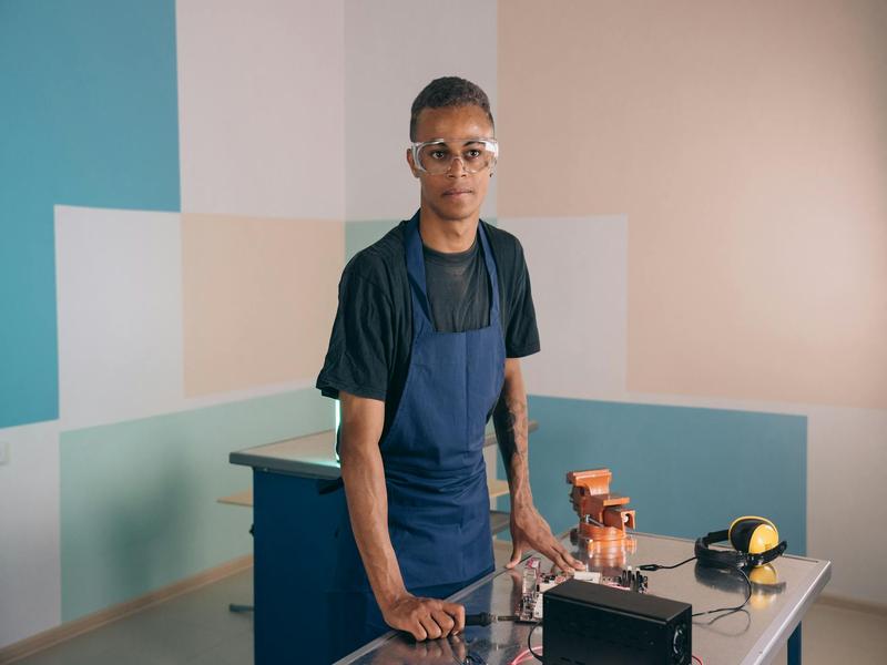 Young woman electrician apprentice at work